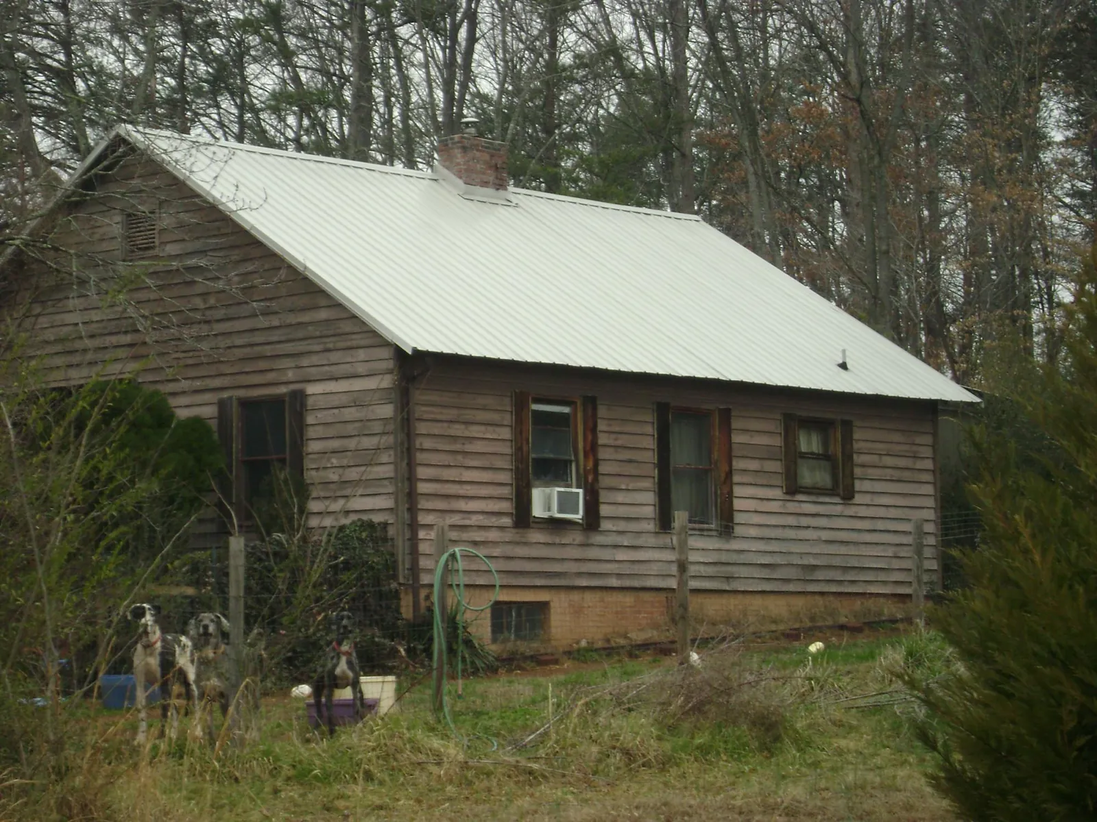 White metal roof on an old wood sided farmhouse, from a Metal Roof Installation job in Soquel